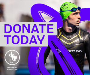 Paralympic Foundation of Canada logo on a grey background. Canadian Para triathlete Stefan Daniel is seen wearing a black wetsuit and a bright green swim cap, looking focused before a race. The words ‘DONATE TODAY’ appear in bold purple text.