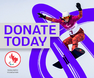 Paralympic Foundation of Canada logo on a light grey background. Canadian Para snowboarder Lisa DeJong is mid-air during a competition, wearing a red and white Team Canada racing suit and a helmet. The words ‘DONATE TODAY’ appear in bold purple text.