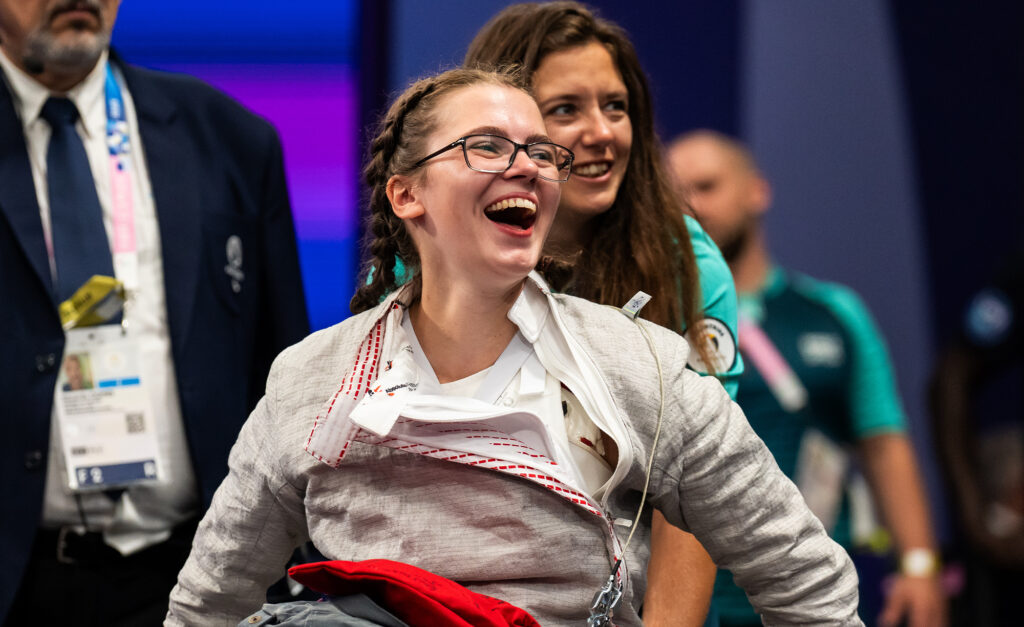 Canadian wheelchair fencer Trinity Lowthian focuses during competition, wearing her fencing jacket and glasses. A proud representative of Canada at the Paris 2024 Paralympic Games.