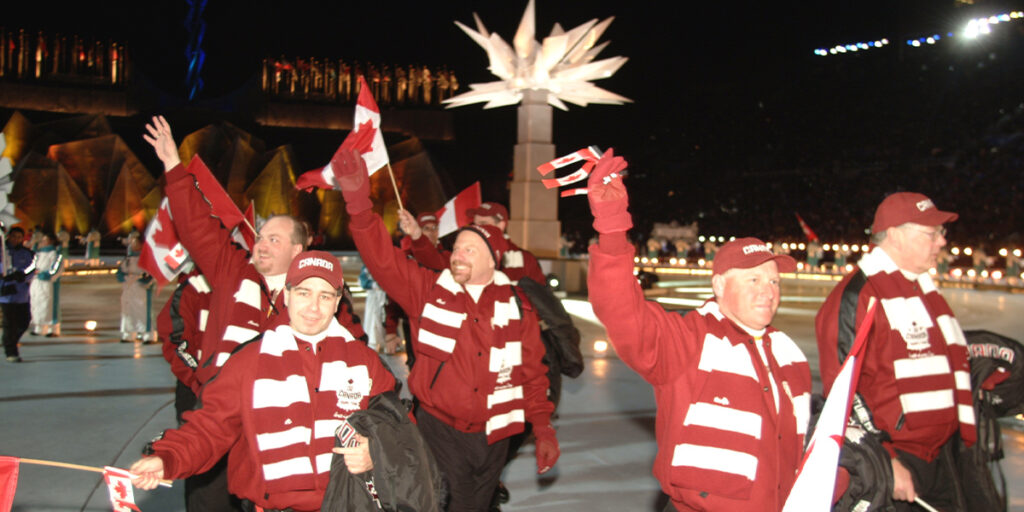 Team Canada athletes wave Canadian flags during the Opening Ceremony of the Salt Lake City 2002 Paralympic Winter Games.