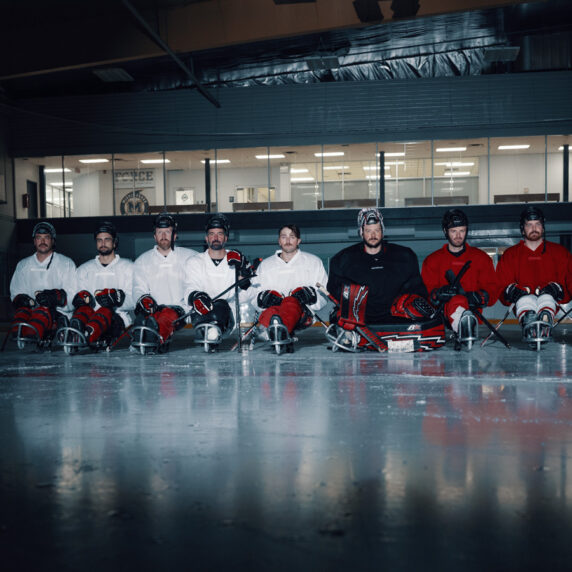 The Para ice hockey team waits on the ice