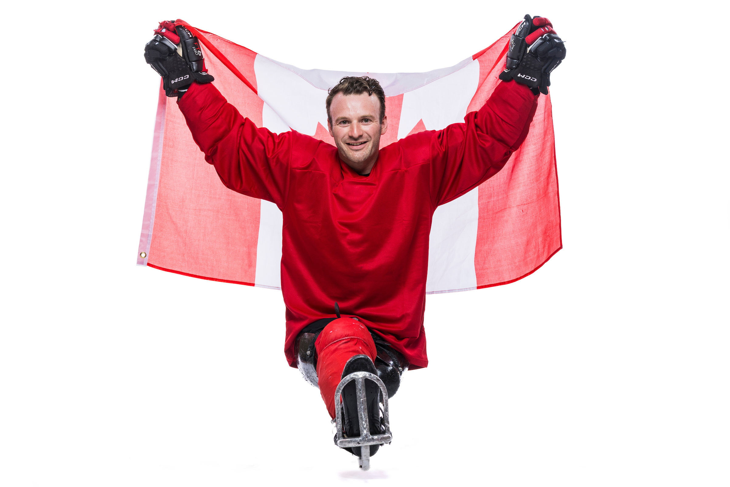 Tyler McGregor holds up a Canada flag